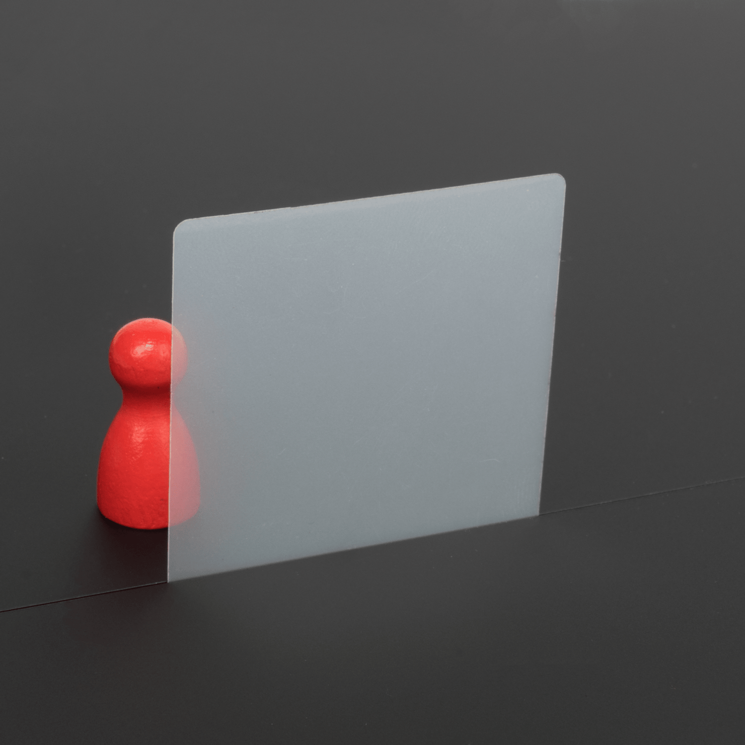 Transparent Mylar foil with red pawn behind it